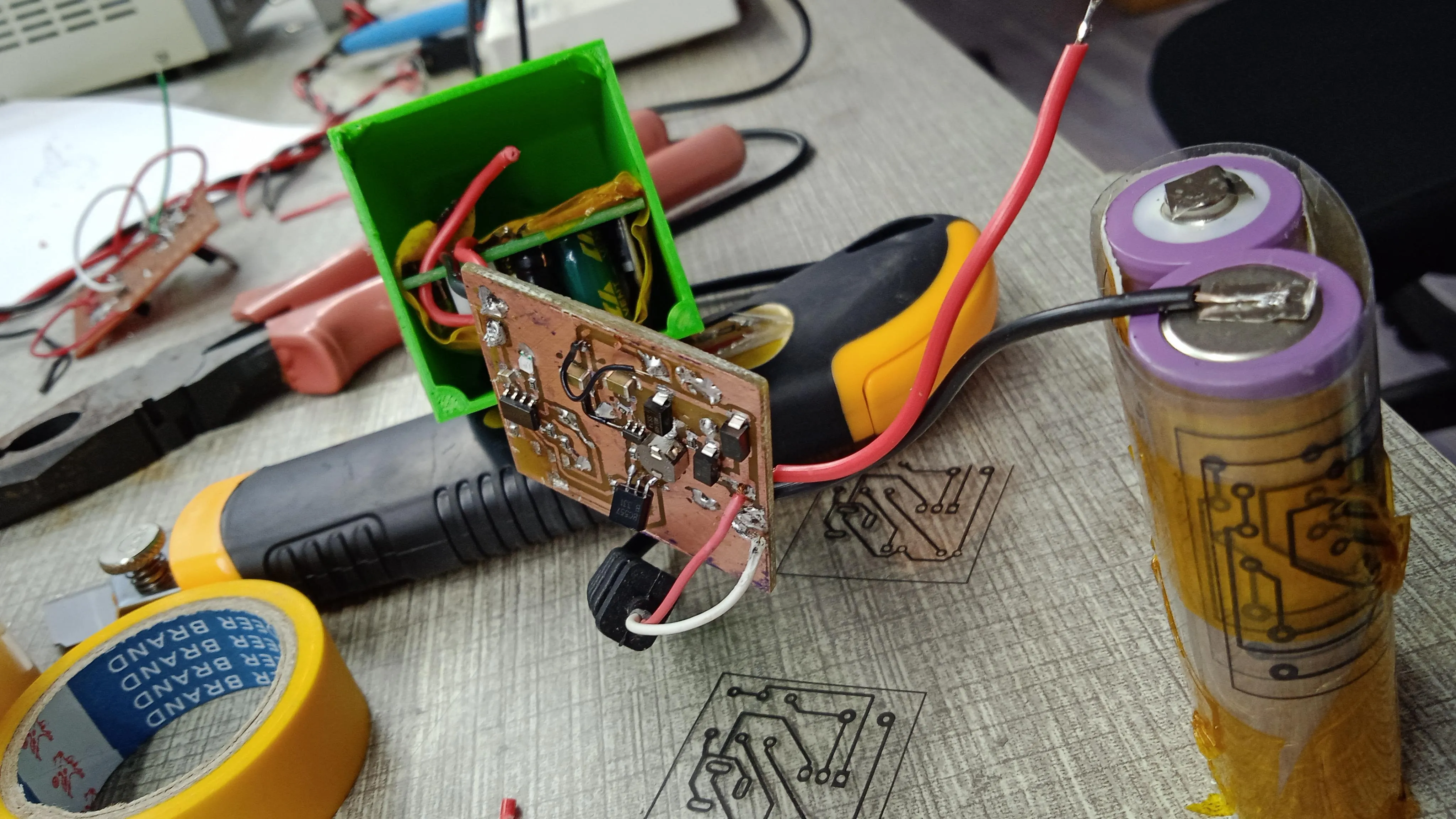 An early prototype: a hand-soldered board wired to an 18650 cell on the bench