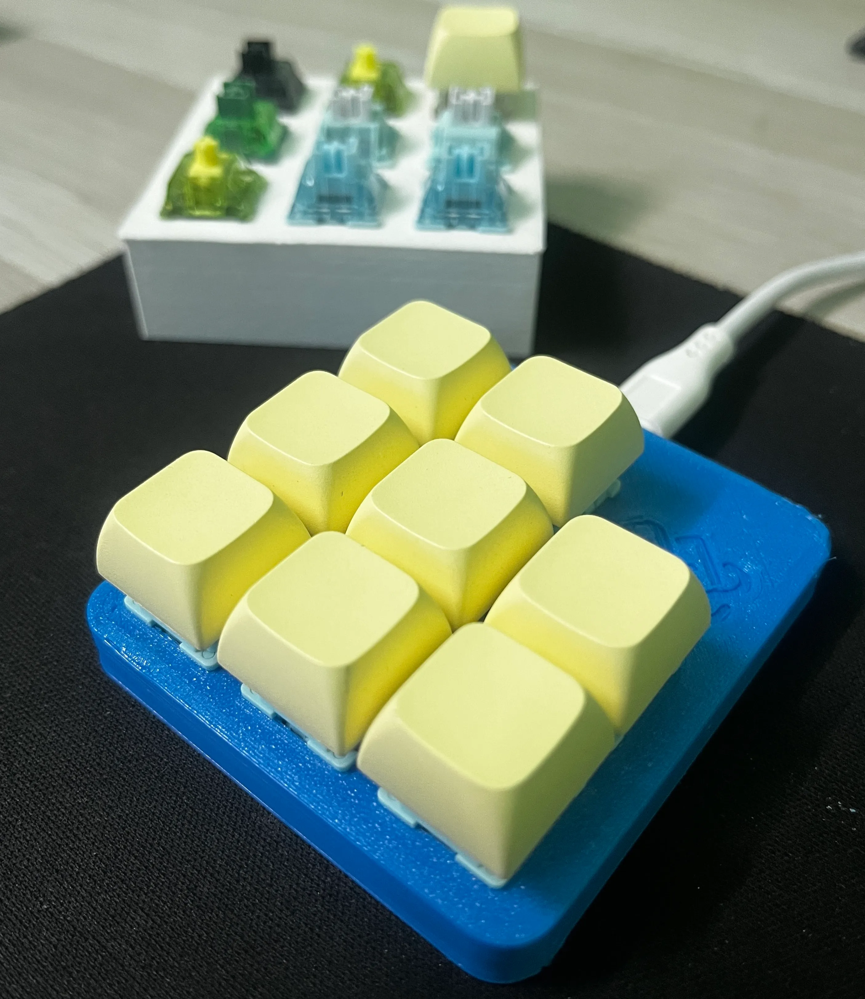 The macropad in its blue 3D printed case with cream keycaps